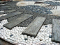 Reflexology path detail of pebble stones and wood planks at the Lokasi Port Dickson Wellness Zone in Malaysia.