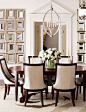 White dining room.  Mirror wall treatment.