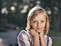 selective focus photography of girl in sequined white-and-pink stripe shirt