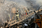 Iranian firefighters work at the scene of the collapsed Plasco building after being engulfed by a fire, in central Tehran, Iran, Thursday, Jan. 19, 2017. Iran's state-run Press TV says dozens of firefighters have been killed in the collapse of a burning h