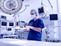 人,设备用品,工作场所,床,技术_125984560_Woman in surgical dress by bed in surgery theatre_创意图片_Getty Images China