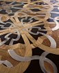 Mosaic floor of wood, stone and steel by Parchettificio