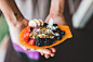 Person Holding Red Black Blue and Orange Fruits