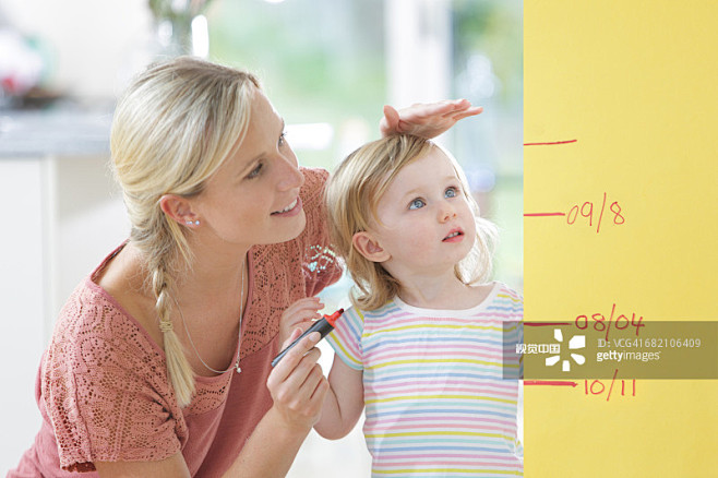 Mother measuring tod...