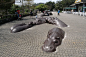 hippo - Bing Images; Sidewalk; sculpture; cement; outdoor; brick;