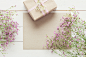 White wooden table with pink flowers and a present, mother's day concept by Andrea Obzerova on 500px