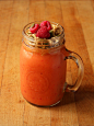 Raspberry Mango Smoothie (approx. 1 cup orange juice, 1 cup frozen mango, and 1/3 cup frozen raspberries) topped with pumpkin flax granola, pumpkin seeds, and fresh raspberries.