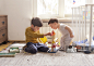 Sibling playing together with wooden toy