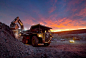Hydraulic shovel and haul truck at iron ore mine at sunset - Mining equipment photo portfolio