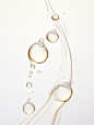 Water drops, in the style of light gold and pure white, realist: lifelike accuracy, graceful balance, clean light and shadow, pure white background