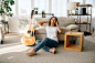 Smiling woman in headphones at home, guita. pretty lady with musical instrument relax in the room, female music lover resting