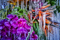 A detail of a sculpture made in the middle of a frozen lake composed of dozens of bouquets of flowers that have been coated with icicles.