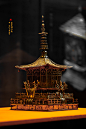 鎏金铜浮屠，唐，陕西扶风法门寺地宫出土，64件首批禁止出国（境）展览文物之一，藏于法门寺博物馆。此浮屠为法门寺唐代木塔的微缩模型，设方形基座，基座上有三层月台，最上层月台上为铜浮屠，面阔、进深均为三间，顶似攒尖顶，柱头斗拱，补间人字拱，当心设门两扇，门中部有插杠，门外置金刚力士一对，攒尖顶上有须弥座，座上有宝刹，出土时置于地宫前室的阿育王塔内，安奉第四枚佛骨舍利。