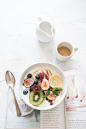 white ceramic plate beside gray steel spoon