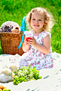 Free Charming little girl resting on plaid in sunny nature Stock Photo