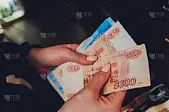 女性手中握着俄罗斯一千卢布的钞票。