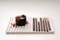 #创意早上好#Chocolate-pencils 巧克力铅笔是日本设计室 Nendo 为甜品店 Tsujiguchi Hironobu 设计甜点。每只笔有不同的标号，代表不同的可可混合比例，并且配备了一个卷笔刀。削下来的碎屑不再是被抛弃的部分，而是食品上的点睛之笔~