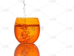 水倒进美丽的橙色玻璃——飞溅。孤立。