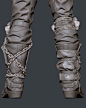 This may contain: a pair of gloves with chains attached to the legs and ankles, all in grey leather