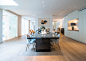 Trendy medium tone wood floor and brown floor dining room photo in London with white walls