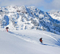 Skiers on a snowy hillside