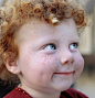 Perfect freckles, blue eyes, dimples, and red curls...