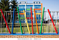 A multi-colored building and a colorful fence of a kindergarten or a children's center: red, blue, yellow, green, orange pipes, a bright house