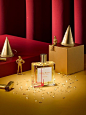 a bottle of perfume sitting on top of a table next to other bottles and figurines