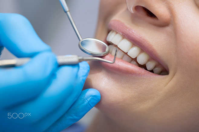 Dentist examining a ...