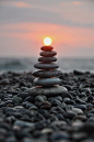 Stacked Pebbles At Sunset