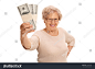 stock-photo-joyful-mature-lady-holding-a-few-stacks-of-money-and-looking-at-the-camera-isolated-on-white-419626204.jpg (1500×1101)