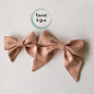 Fabric bow headbands in a linen blend fabric made in the classic Sailor Bow style on nylon headbands. Bows available in two sizes and lot of colors making it the perfect accessory!The larger bow measures approximately 4.5" wide and 5" at its lon