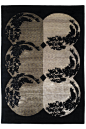 This may contain: a black and white rug with four circular designs on the front, two in the middle