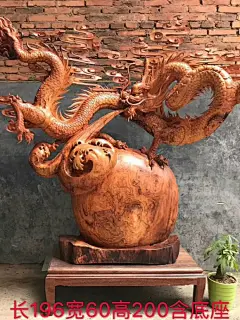 This may contain: a wooden vase with two dragon heads on it's head and one in the air