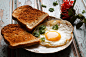 a fried egg with bread by Luiz Laercio on 500px