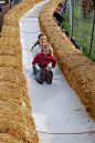 Oh my goodness! A slide made from straw bales, slippery 'boards' and a hill! (more photos and ideas in the post)