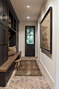 French country brick floor entryway photo in Denver with a black front door