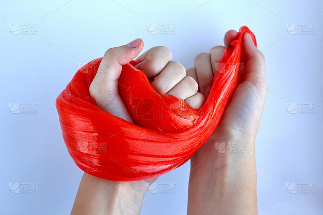 孩子们手中的鲜红色黏液。教育、创造力、童年观念。有选择性的重点。