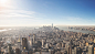 An aerial view of New York City's skyline and skyscrapers on a bright, sunny day