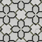 This may contain: a white and black tiled wall with geometric designs