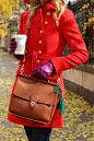 red coat + a classic coach bag. love the purple and green accents!