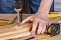 Midsection of man working on wood