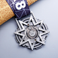 This may contain: a medal with a ribbon around it on top of a table