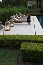 smooth palest limestone terrace with elegant loungers and lanterns | clipped…: 