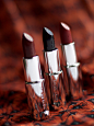 selective focus photography of three assorted-color lipsticks