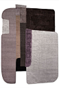 This may contain: three rugs with different colors and shapes on the same flooring area, one is grey