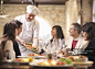 Chef serving people in restaurant