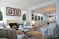 This is an example of a coastal living room in London with blue walls and feature lighting.
