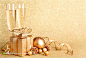 圣诞节金色装饰礼物盒彩球与高脚酒杯高清设计背景图片素材