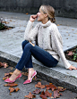 NYC fashion blogger Mary Orton wears a chunky cable-knit turtleneck, distressed dark-wash skinny jeans and pink velvet SJP pumps